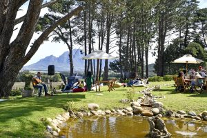 Topiary Wine Estate garden dining next to the water side. Topiary Wine Estate garden