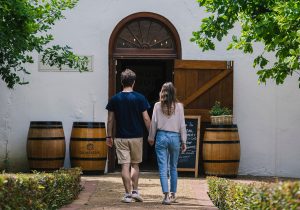 Diemersdal Wine Estate cellar with people walking into the entrance. Diemersdal Wine Estate cellar